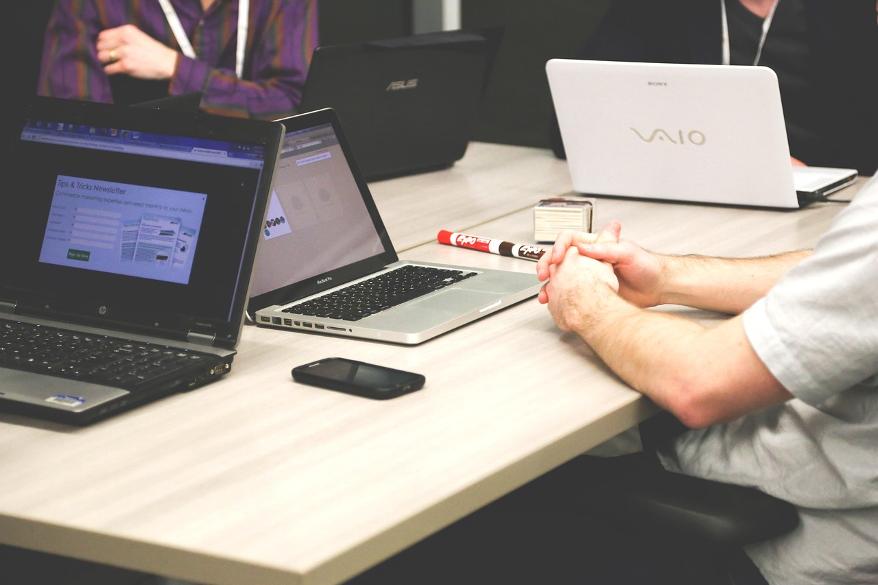 Professional bookkeeper working at modern office desk with laptop and financial documents